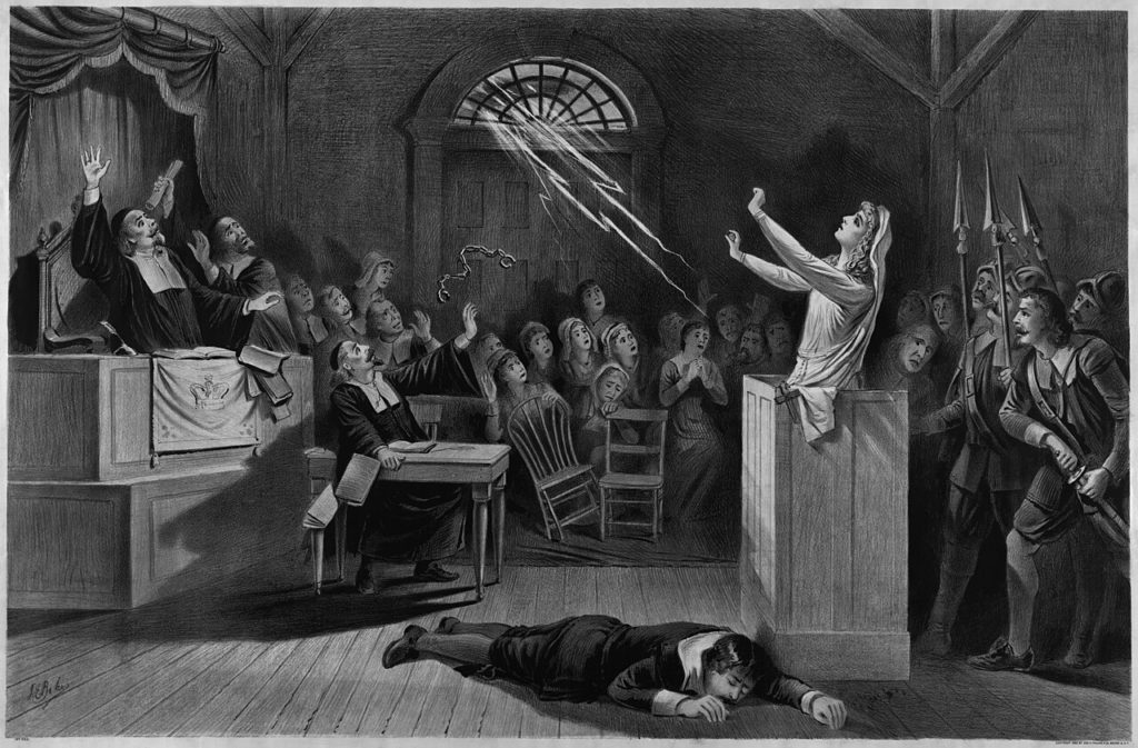 A dramatic courtroom scene showing a woman in white with arms raised, facing an audience filled with fear. Lightning illuminates the room, highlighting the tense atmosphere.